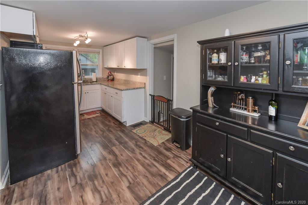 1239 Log Cabin Road Charlotte, NC 28213 - Photo 5 of 26 a kitchen with a refrigerator and cabinets