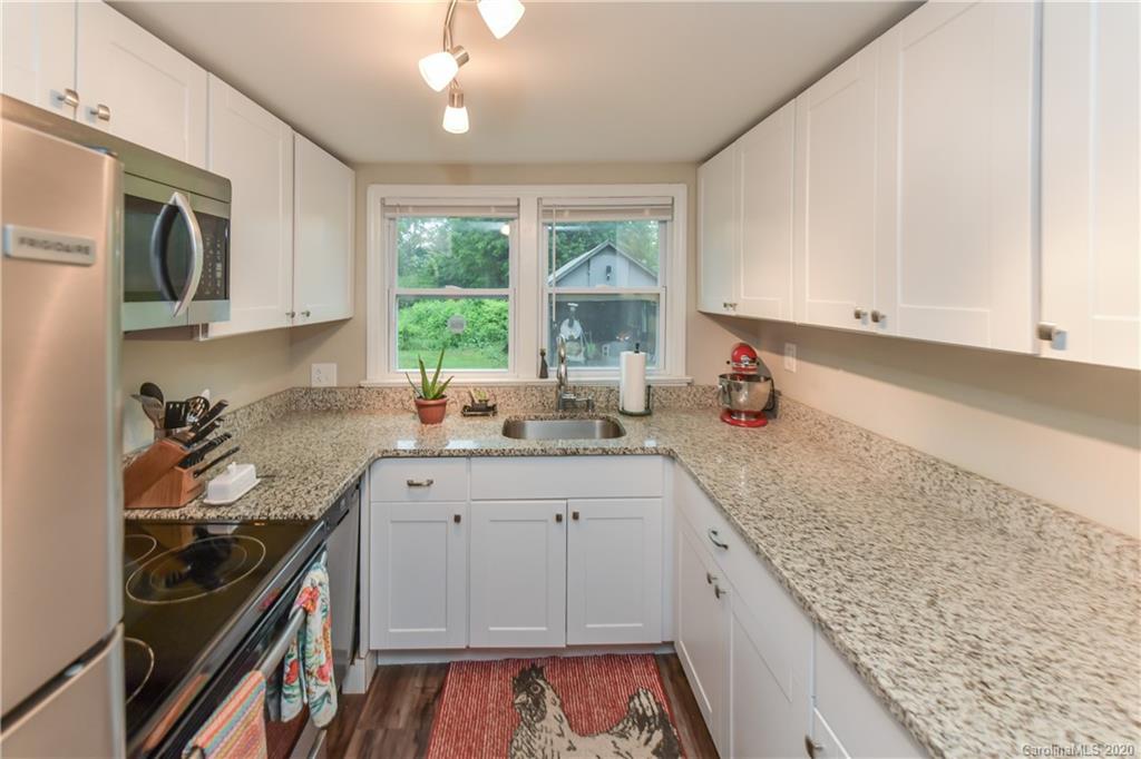 1239 Log Cabin Road Charlotte, NC 28213 - Photo 6 of 26 a kitchen with stainless steel appliances granite countertop a sink stove and cabinets