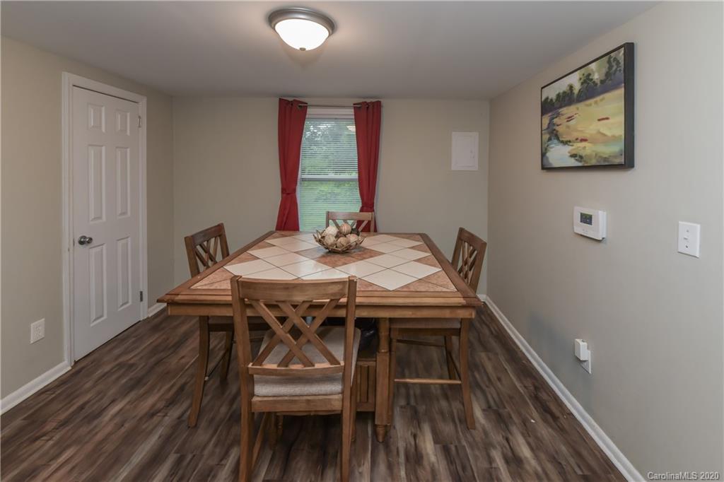 1239 Log Cabin Road Charlotte, NC 28213 - Photo 9 of 26 a view of a dining room with furniture and wooden floor