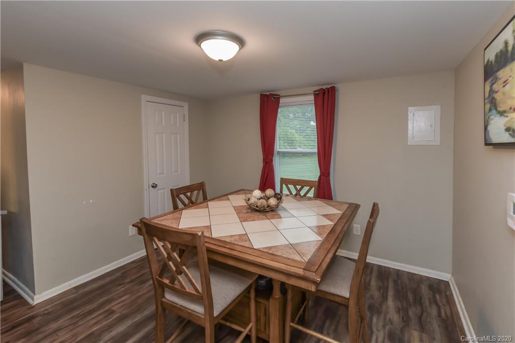 1239 Log Cabin Road Charlotte, NC 28213 - Photo 10 of 26 a view of a dining room with furniture and wooden floor