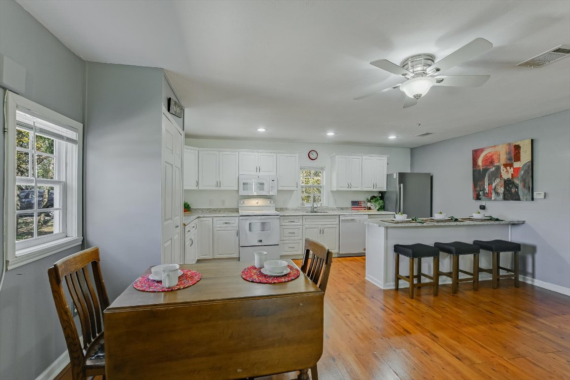 1001 Indian Springs Road Georgetown, TX 78633 - Photo 11 of 30 a living room with stainless steel appliances kitchen island granite countertop furniture and wooden floor
