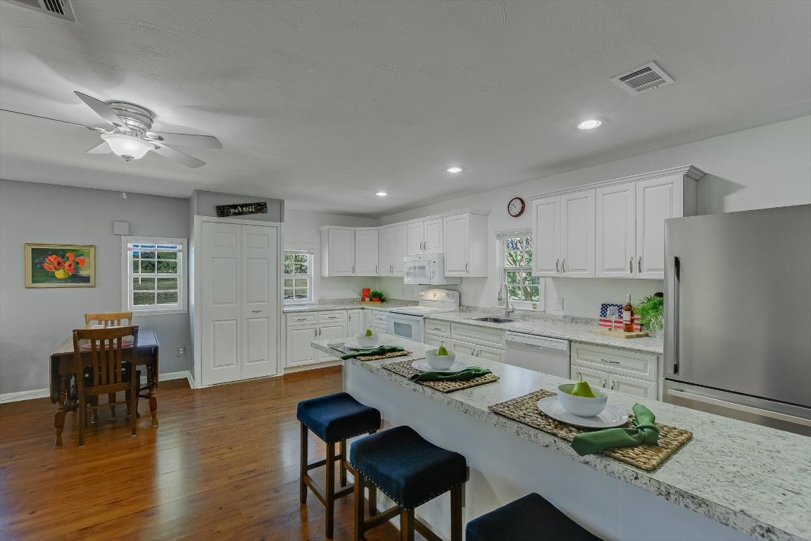 1001 Indian Springs Road Georgetown, TX 78633 - Photo 13 of 30 a kitchen with a dining table chairs and refrigerator