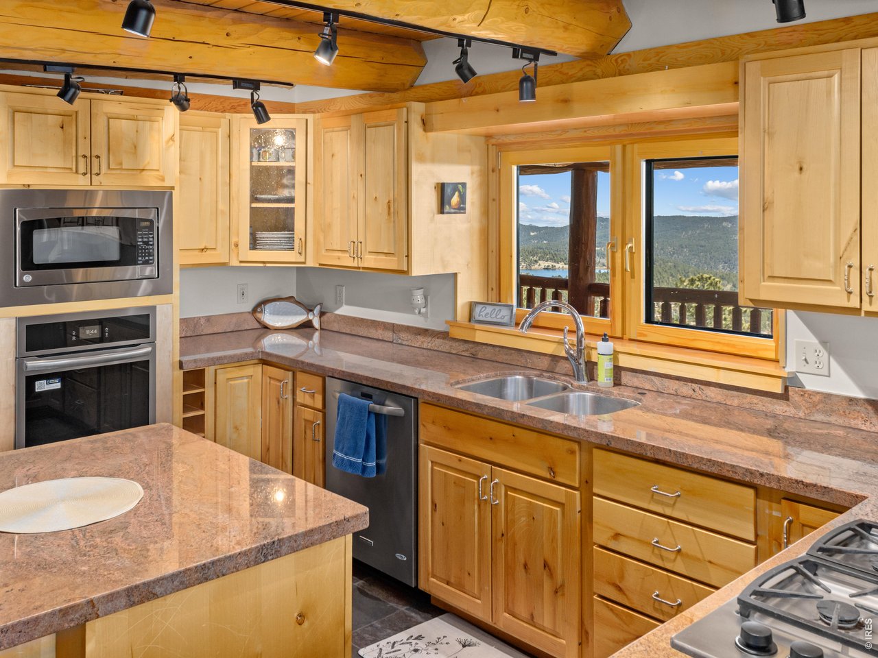 1398 Gold Lake Road Ward, CO 80481 - Photo 15 of 39 a kitchen with stainless steel appliances granite countertop a sink a stove and a microwave oven