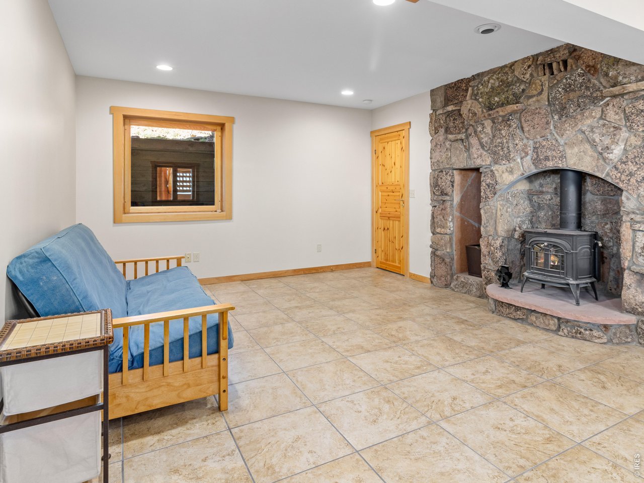 1398 Gold Lake Road Ward, CO 80481 - Photo 26 of 39 a bedroom with furniture and a fireplace