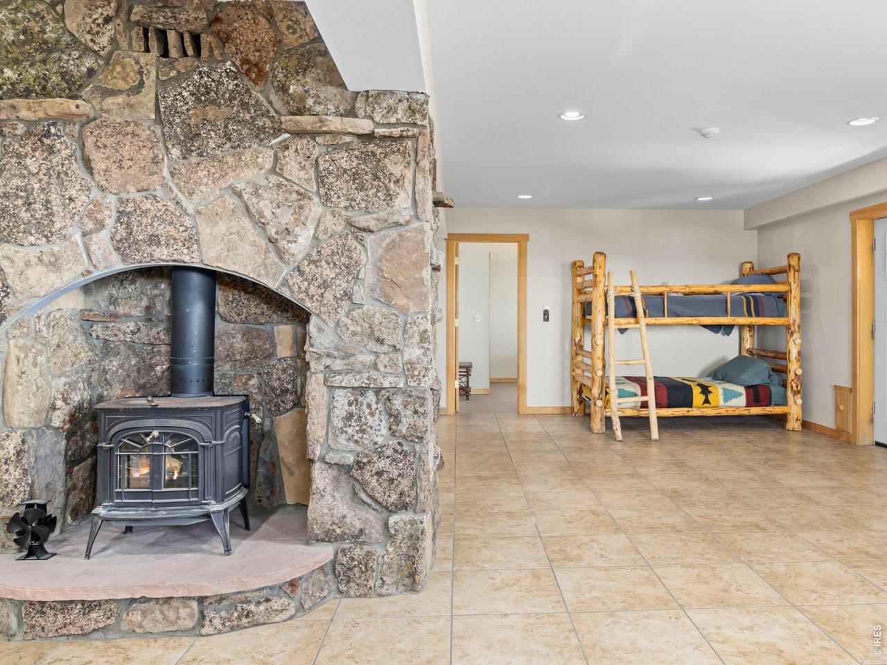 1398 Gold Lake Road Ward, CO 80481 - Photo 27 of 39 a living room with furniture and a fireplace