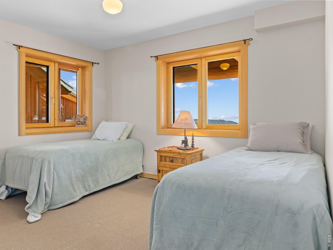 1398 Gold Lake Road Ward, CO 80481 - Photo 28 of 39 a bedroom with bed and window