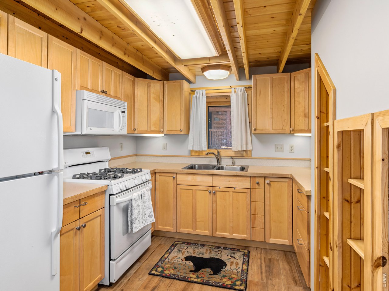 1398 Gold Lake Road Ward, CO 80481 - Photo 31 of 39 a kitchen with stainless steel appliances granite countertop a sink a stove and a refrigerator