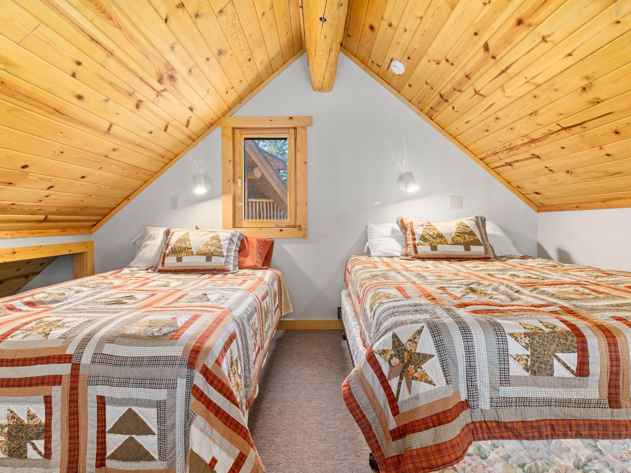 1398 Gold Lake Road Ward, CO 80481 - Photo 32 of 39 a bedroom with double bed and a window