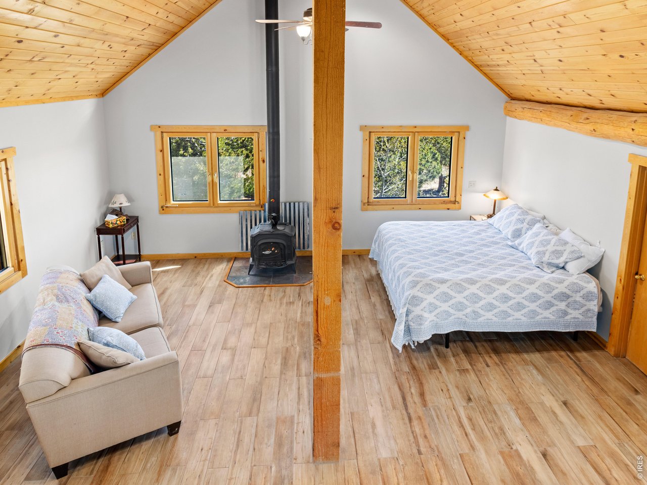 1398 Gold Lake Road Ward, CO 80481 - Photo 33 of 39 a bedroom with a bed and wooden floor