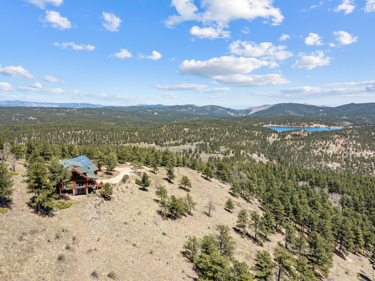 1398 Gold Lake Road Ward, CO 80481 - Photo 4 of 39 a view of a lake with mountains in the background