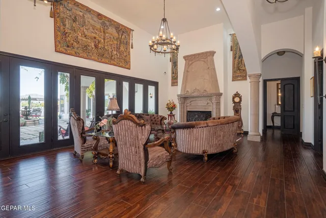 a living room with furniture a window and wooden floor