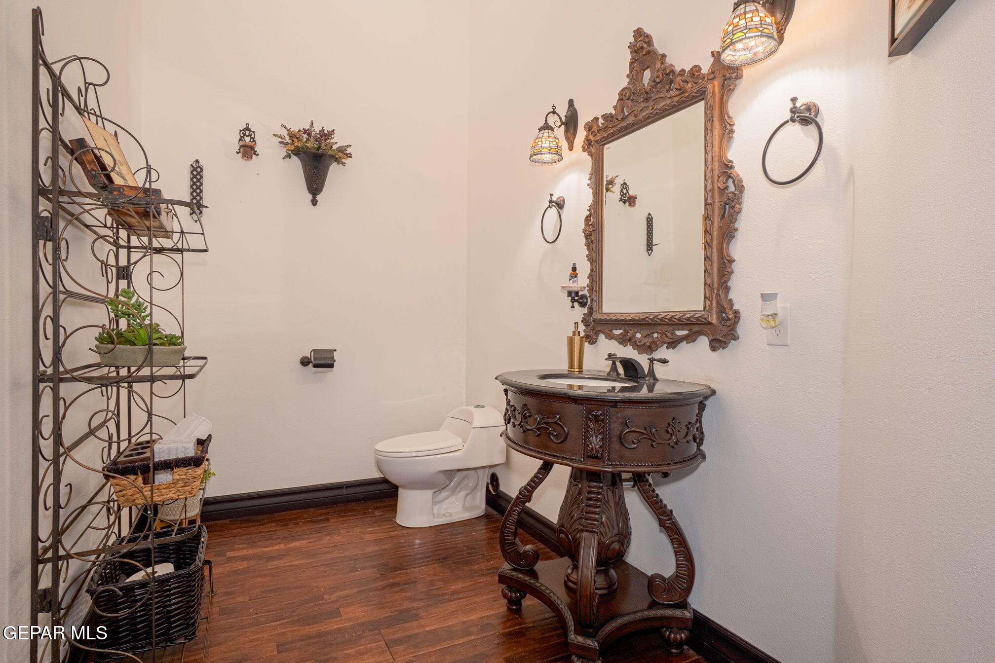 6750 Gato Road El Paso, TX 79932 - Photo 28 of 43 a bathroom with a sink a mirror and a toilet