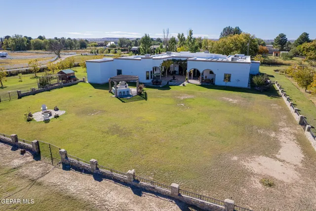a view of yard with swimming pool and trees in the background