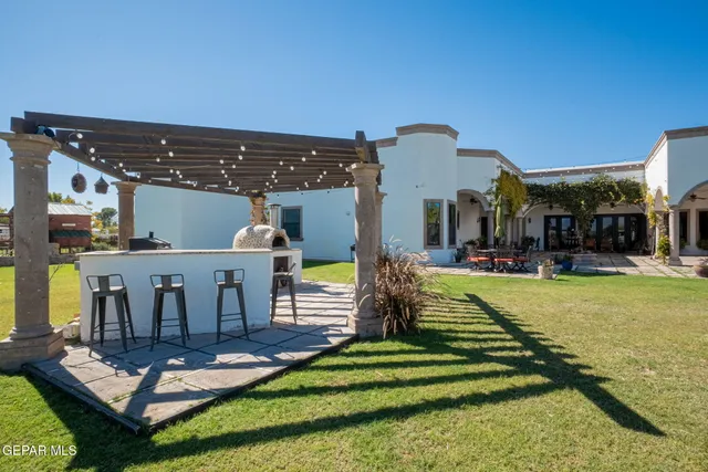a front view of a house with a yard table and chairs