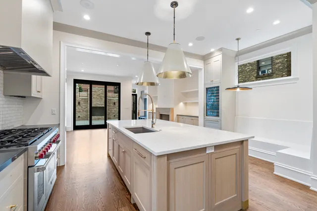 a kitchen with granite countertop white cabinets and a sink