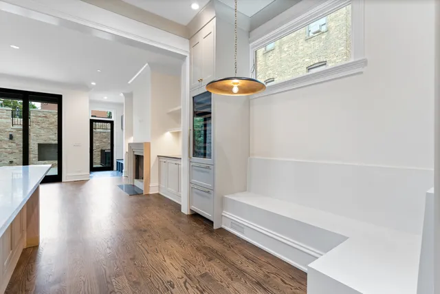 a view of a kitchen with a sink and a fireplace