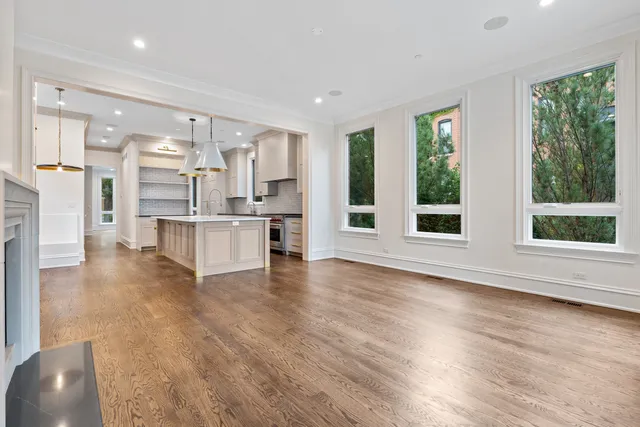 a view of an empty room with glass door and a window