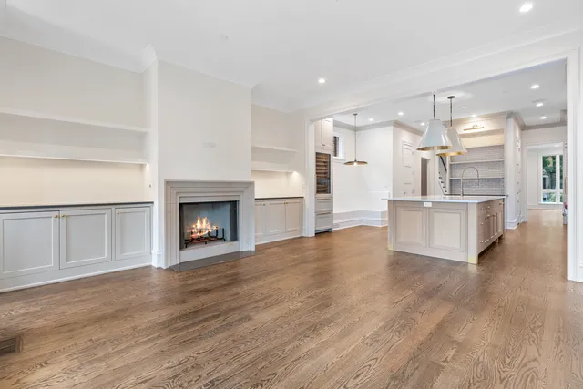 a view of an empty room with window and fire place
