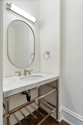 a bathroom with a granite countertop sink double vanity and a mirror