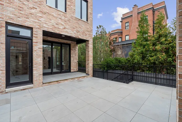 a view of a living room with a black white checkered floor next to a window