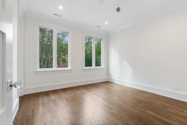 a bathroom with a toilet a sink a mirror and vanity
