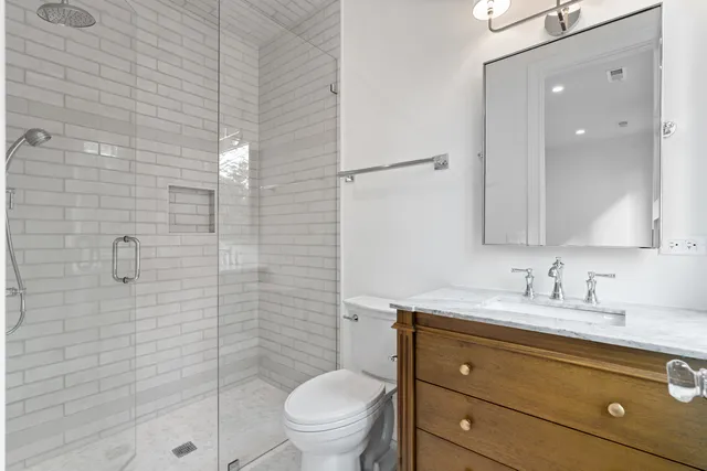a view of an empty room with stairs and a window