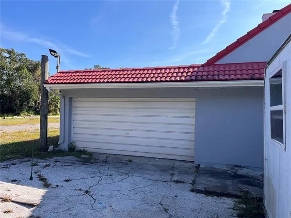 a view of a house with a yard and garage