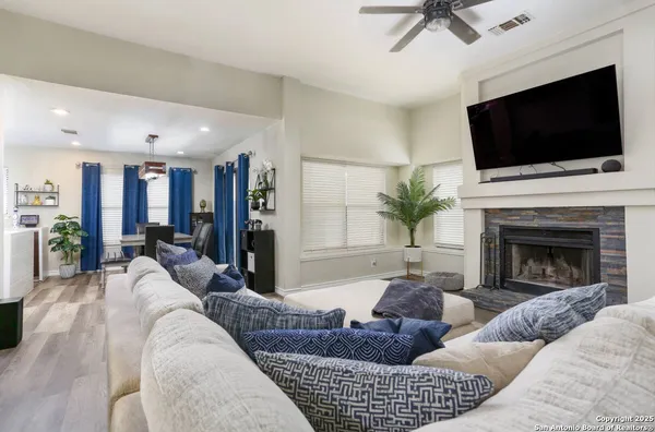a living room with furniture a fireplace and a flat screen tv
