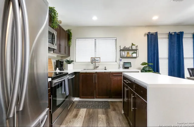 a kitchen with a sink stove and refrigerator