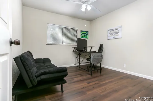 a workspace room with furniture and wooden floor