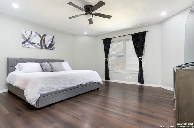 a bedroom with a bed and a painting on the wall