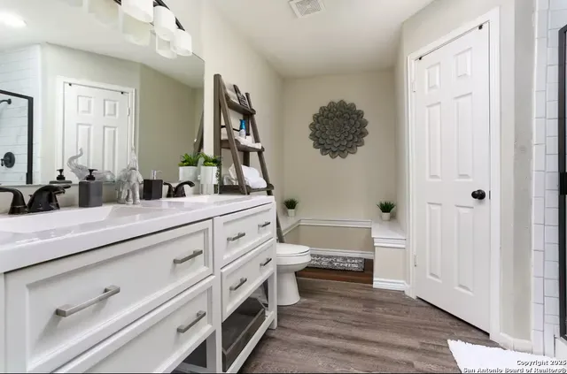 a bathroom with a double vanity sink a mirror and a bathtub