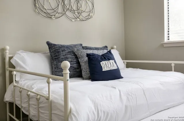 a bedroom with a bed and a window