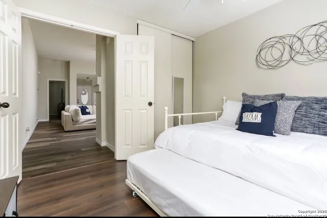 a bedroom with a bed and a mirror