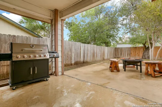 a view of outdoor kitchen with outdoor seating and barbeque oven