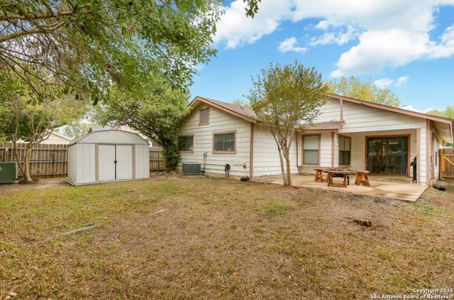 a white house with a large tree in front of it