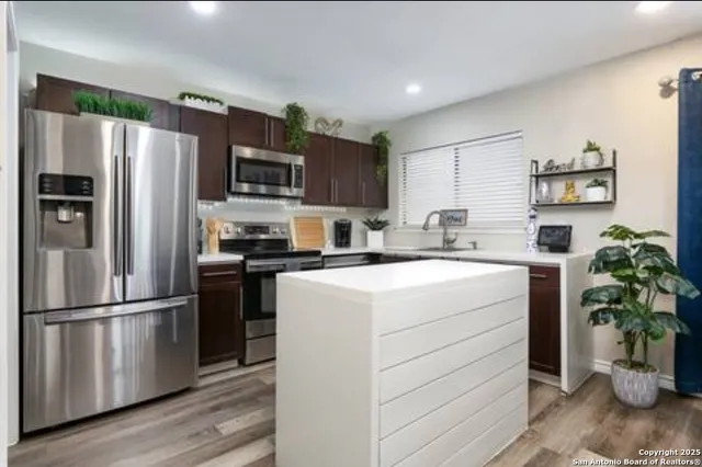 a kitchen with a refrigerator stove and a sink
