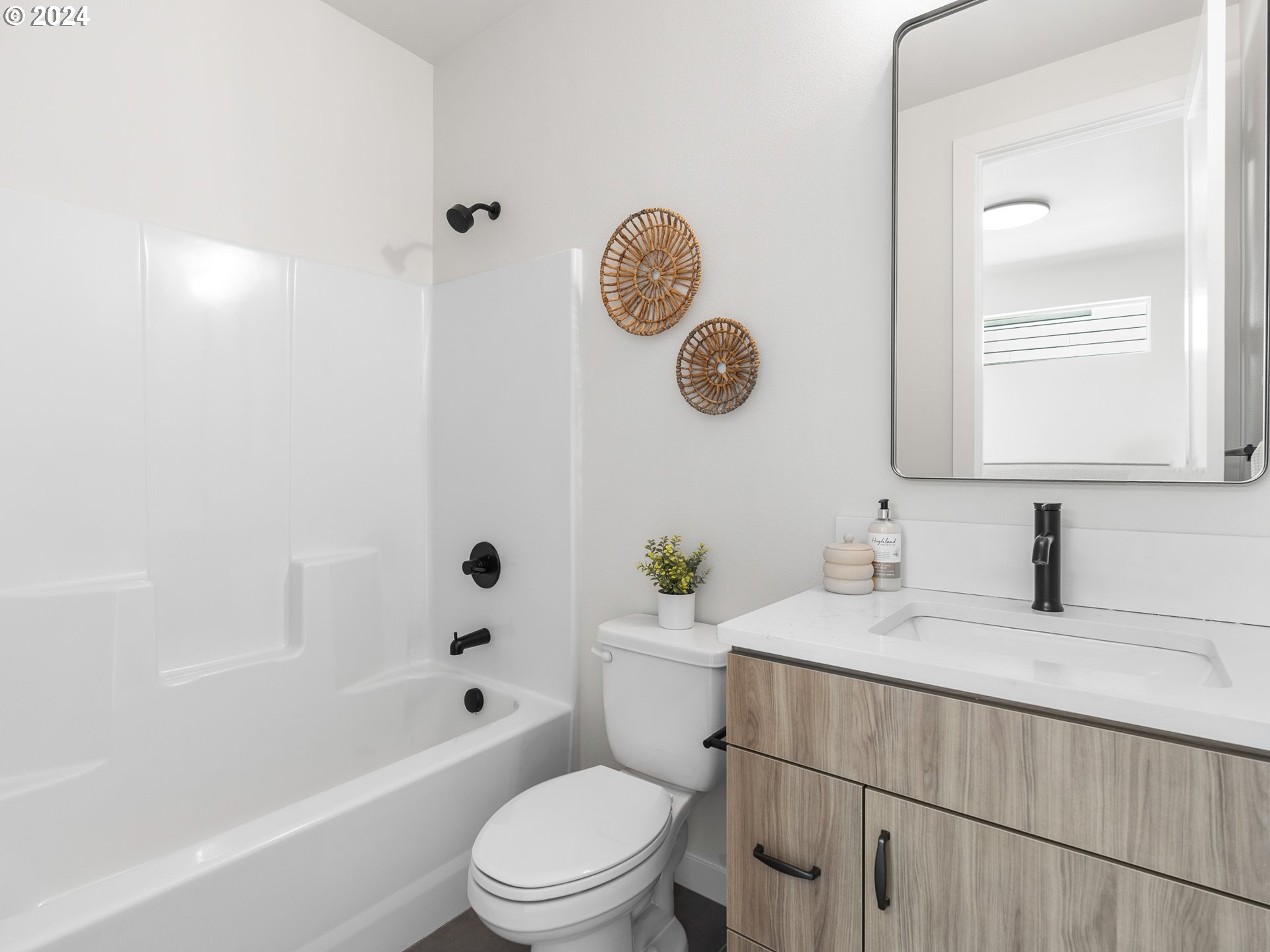 457 Northeast 74th Avenue, Unit 1 Portland, OR 97213 - Photo 17 of 26 a bathroom with a toilet a sink and mirror
