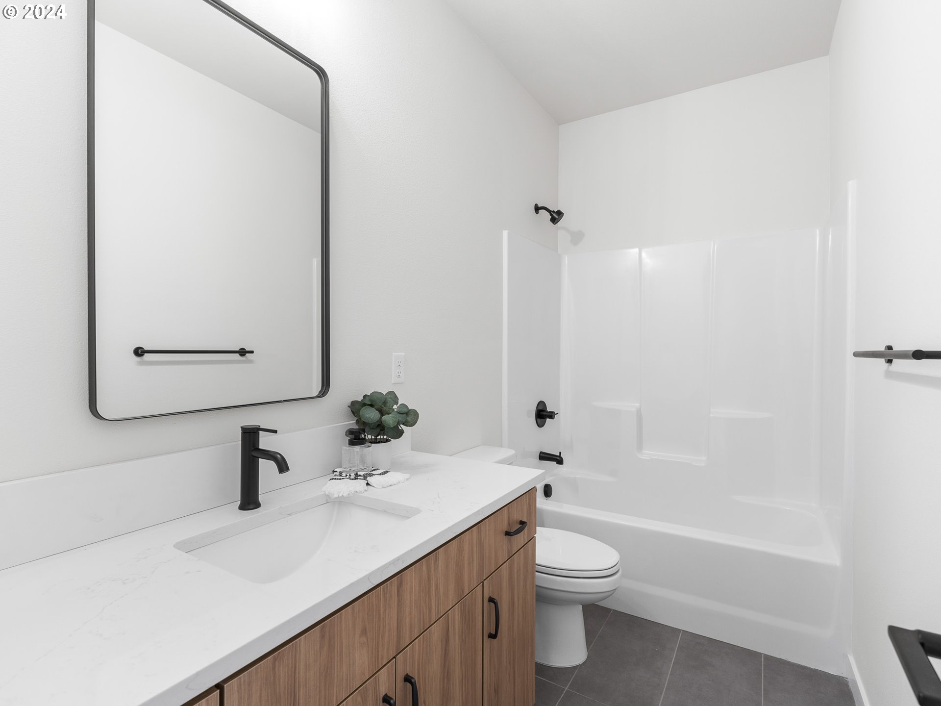 457 Northeast 74th Avenue, Unit 1 Portland, OR 97213 - Photo 19 of 26 a bathroom with a sink a toilet and shower