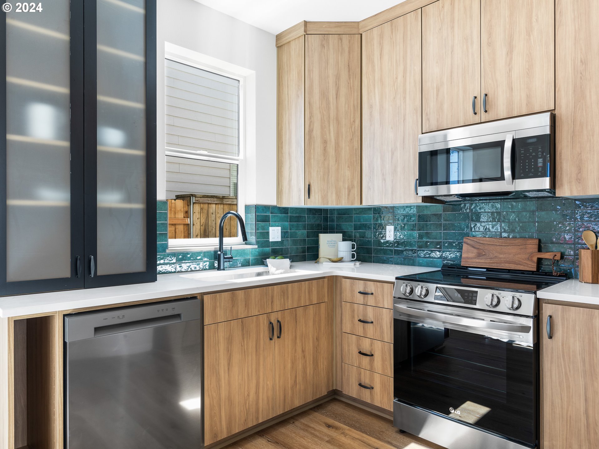 457 Northeast 74th Avenue, Unit 1 Portland, OR 97213 - Photo 8 of 26 a kitchen with stainless steel appliances granite countertop a stove a sink and a microwave