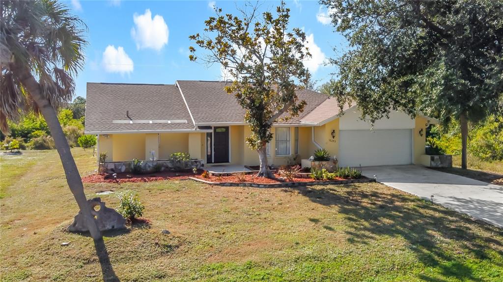 10253 Winstead Avenue Englewood, FL 34224 - Photo 1 of 46 a view of a house with backyard porch and sitting area