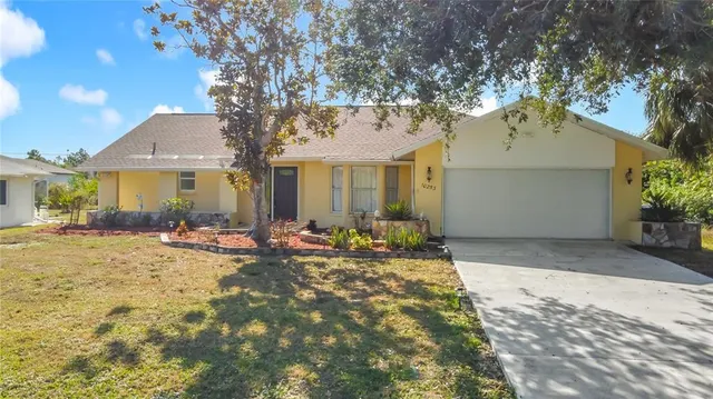 a view of a house with backyard and sitting area