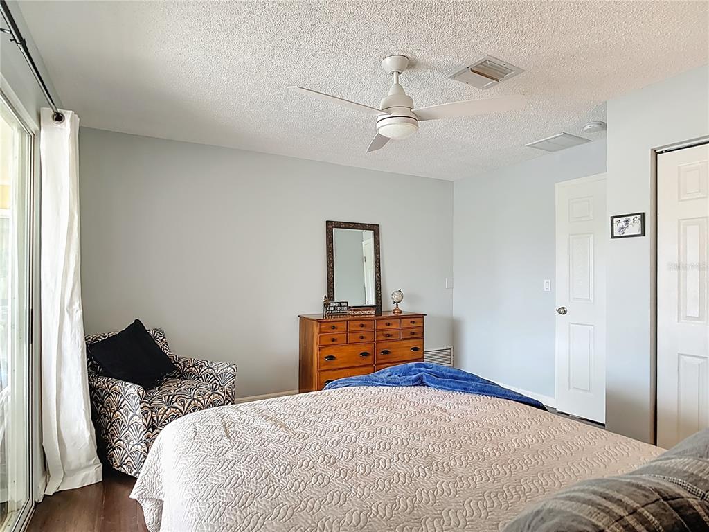 10253 Winstead Avenue Englewood, FL 34224 - Photo 13 of 46 a bedroom with a bed and wooden floor