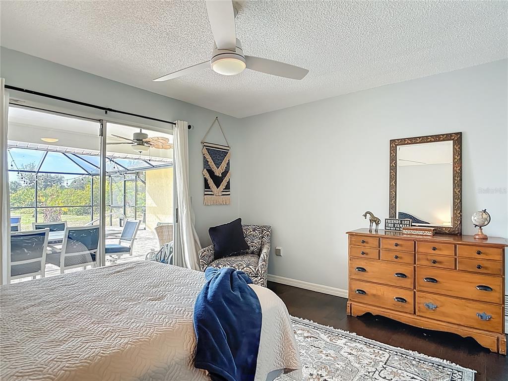 10253 Winstead Avenue Englewood, FL 34224 - Photo 16 of 46 a bedroom with a bed and wooden floor