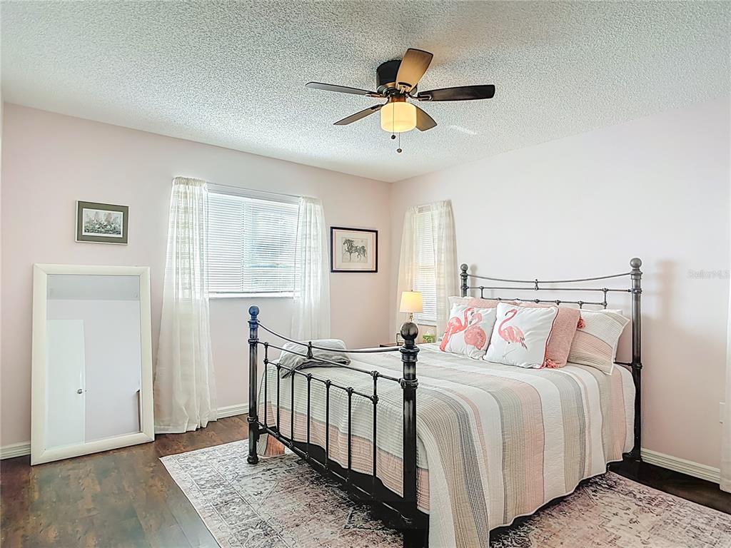 10253 Winstead Avenue Englewood, FL 34224 - Photo 20 of 46 a bedroom with a large bed and a chandelier