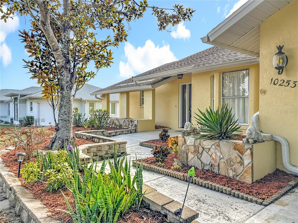 10253 Winstead Avenue Englewood, FL 34224 - Photo 2 of 46 a front view of a house with garden