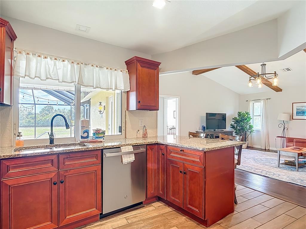 10253 Winstead Avenue Englewood, FL 34224 - Photo 25 of 46 a kitchen with a sink stove and cabinets