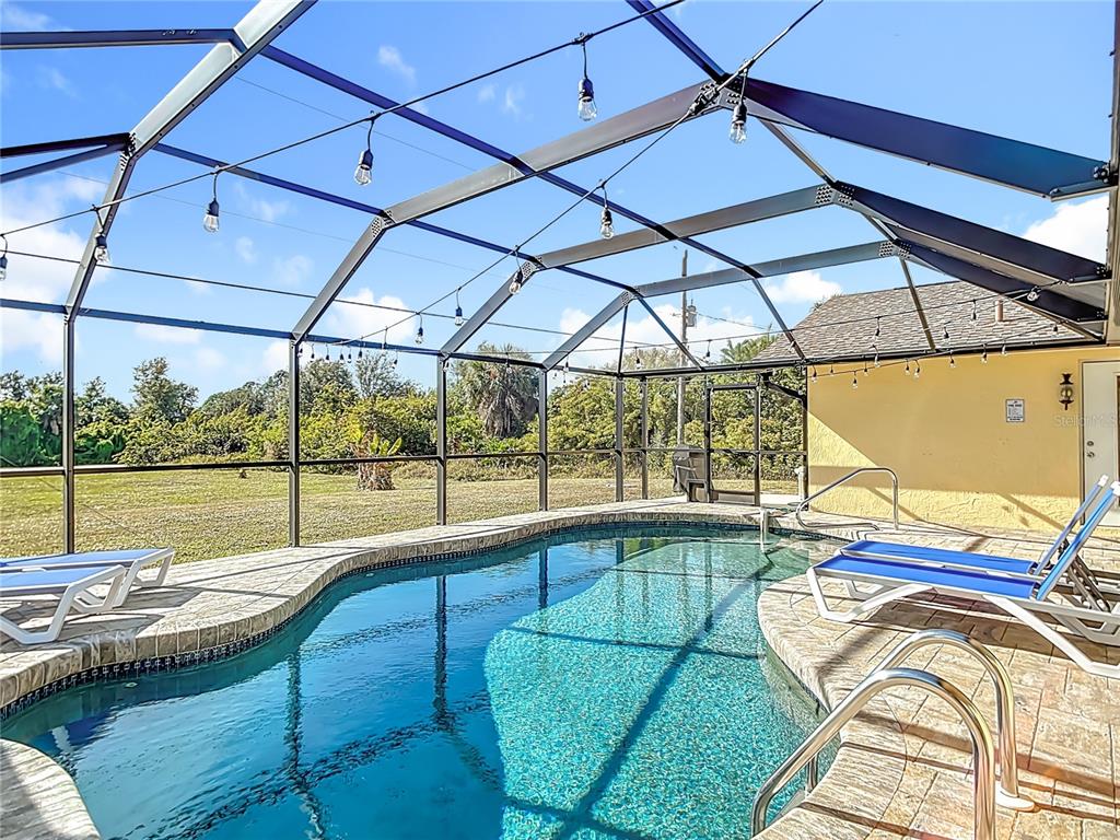 10253 Winstead Avenue Englewood, FL 34224 - Photo 35 of 46 a view of a swimming pool with a patio
