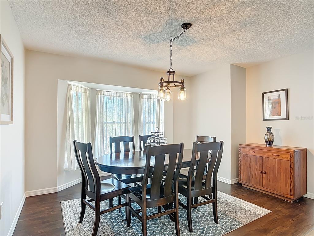 10253 Winstead Avenue Englewood, FL 34224 - Photo 6 of 46 a view of a dining room with furniture window and wooden floor