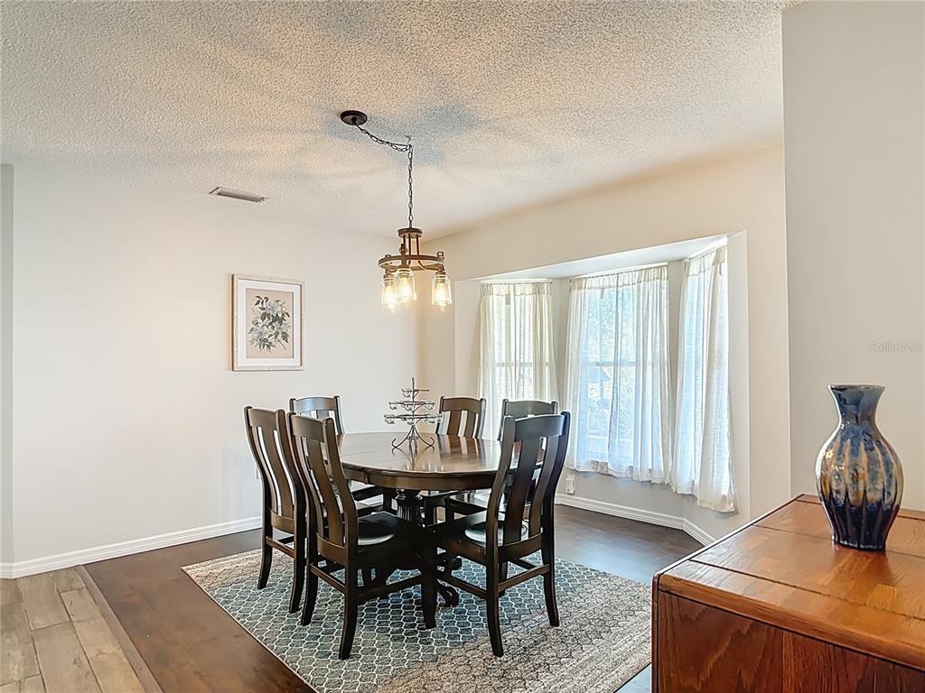 10253 Winstead Avenue Englewood, FL 34224 - Photo 7 of 46 a view of a dining room with furniture window and wooden floor
